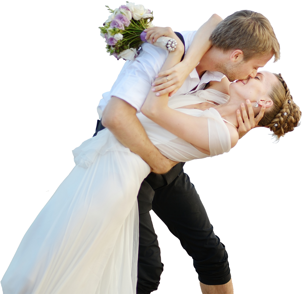 Newly married couple dances a dip on the beach.